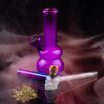 purple glass bong with pipe pile weed drug tools marijuana use How to Clean Cannabis Gear