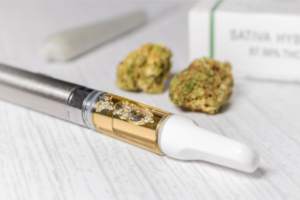 Cannabis products are displayed such as a vape cartridge, a preroll, two buds, and a packaged box to show what to to expect from the best store